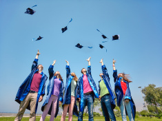 stock-photo-87067377-graduates-tossing-caps-into-the-air