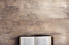 stock-photo-59726462-bible-on-a-wooden-desk
