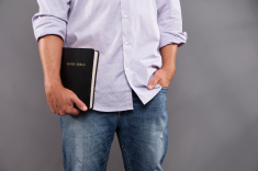 stock-photo-21740909-man-casually-holds-bible