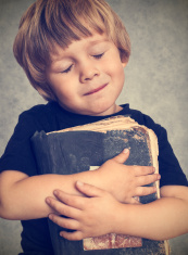 stock-photo-22361557-little-boy-hugging-an-old-book